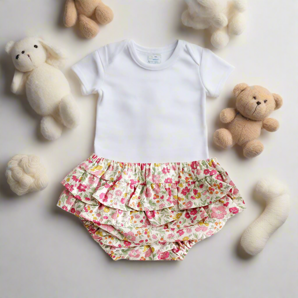 Floral ruffled baby bloomers on a white background