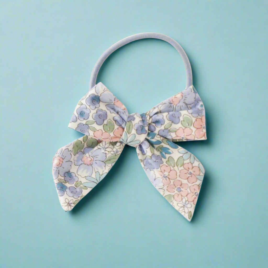 Floral bow hair tie on a white background