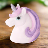 Unicorn-shaped object with purple mane and horn on a white background